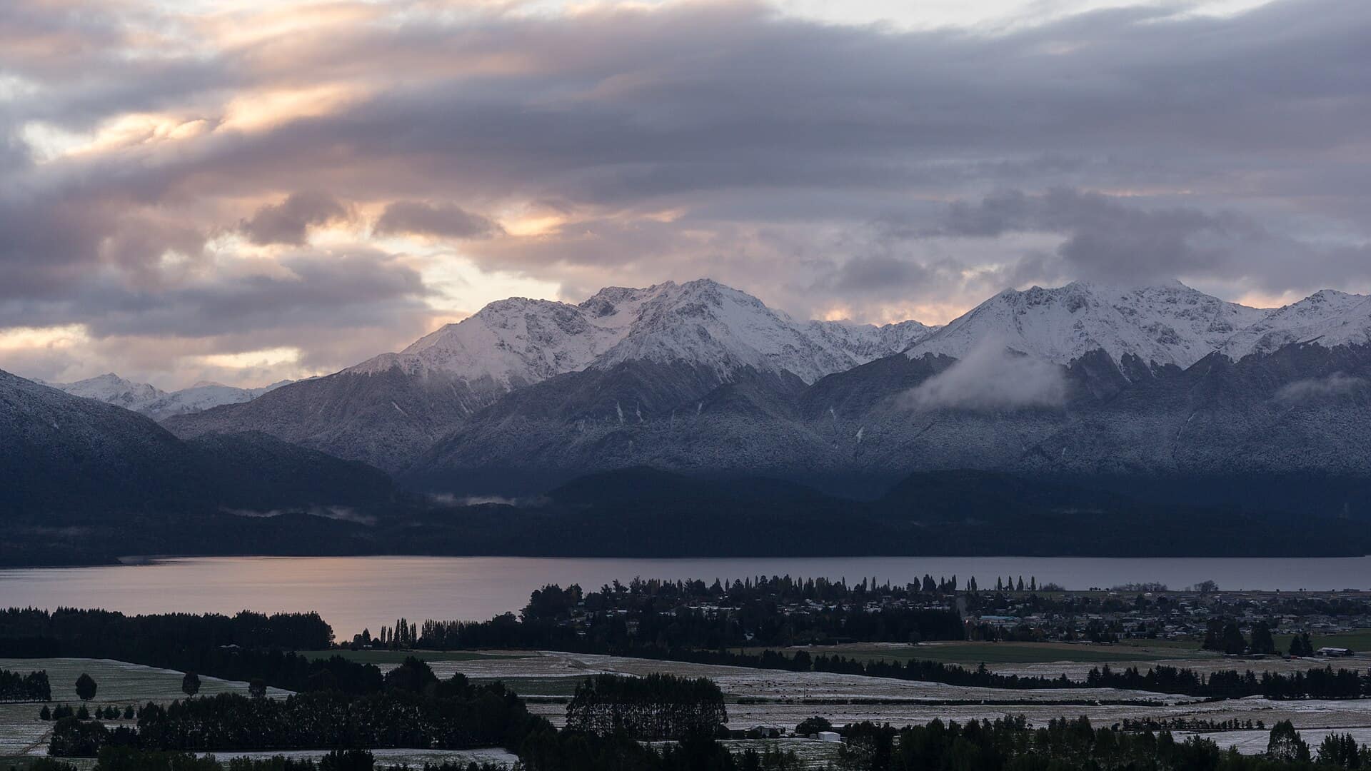 Te Anau, New Zealand: Te Anau with the Murchison Mountains in the background. Taken at dusk on the first day of snow fall in 2015.